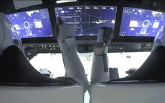 Imagem da Nasa TV mostra os astronautas monitorando os controles do SpaceX enquanto a cápsula se aproxima da ISS