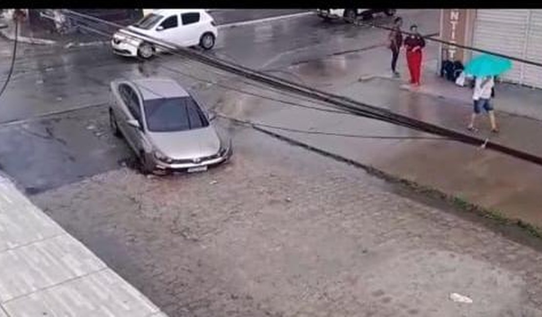 Após chuvas, buraco na pista  ‘engole’ carro no bairro Clima Bom