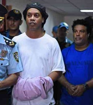 Após noite na prisão, Ronaldinho e Assis são algemados e levados para prestar depoimento