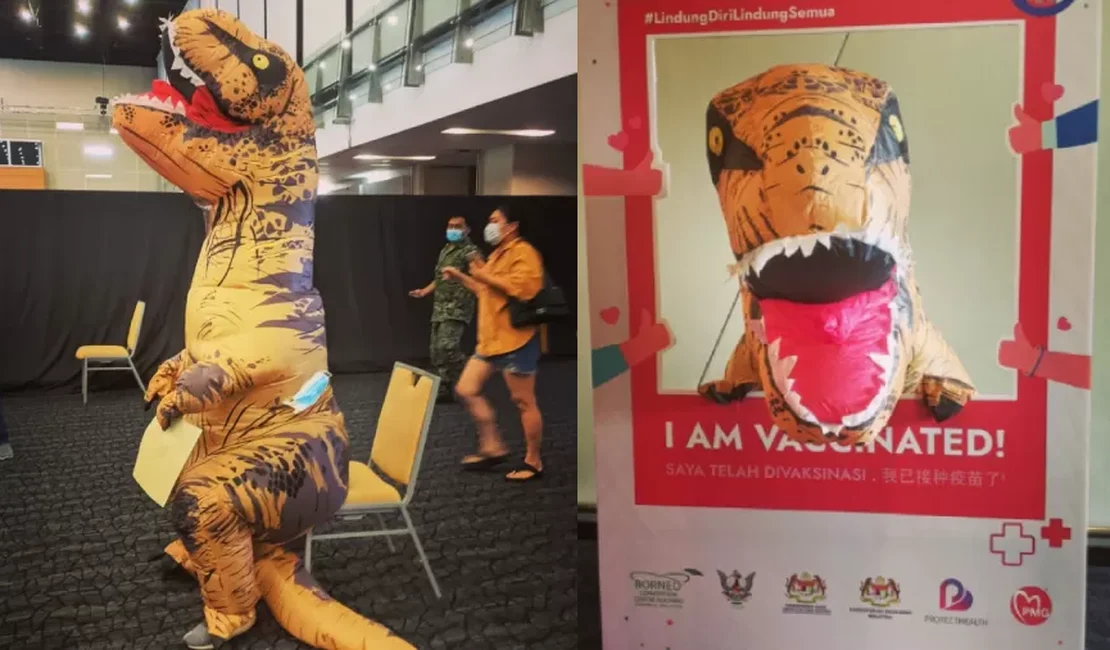 Homem toma vacina contra covid fantasiado de tiranossauro na Malásia.