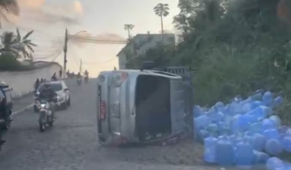 Caminhão carregado com água mineral capota no bairro do Jacintinho, em Maceió
