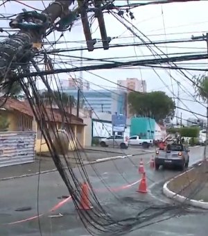 Caminhão se enrosca com fios elétricos, puxa poste e rua fica interditada no Farol