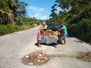 Moradores tapam buracos da rodovia AL 101 Norte com metralhas